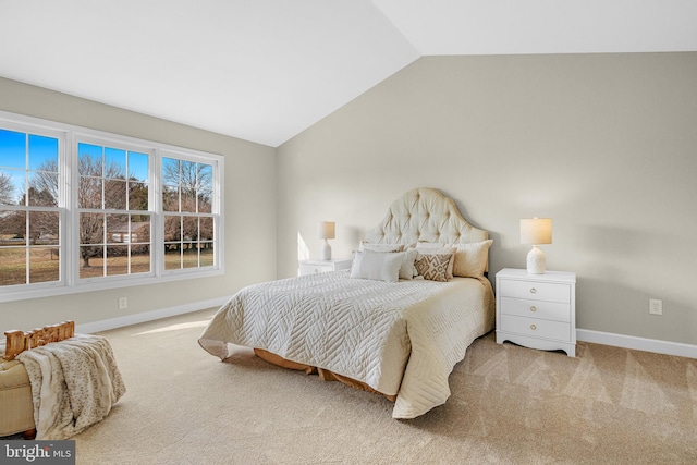 carpeted bedroom with lofted ceiling