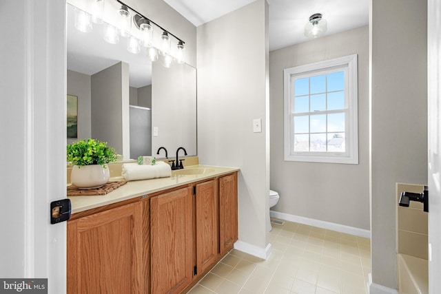 bathroom with tile patterned flooring, vanity, toilet, and walk in shower