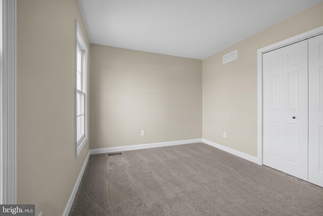 spare room featuring carpet