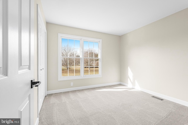 empty room featuring light colored carpet