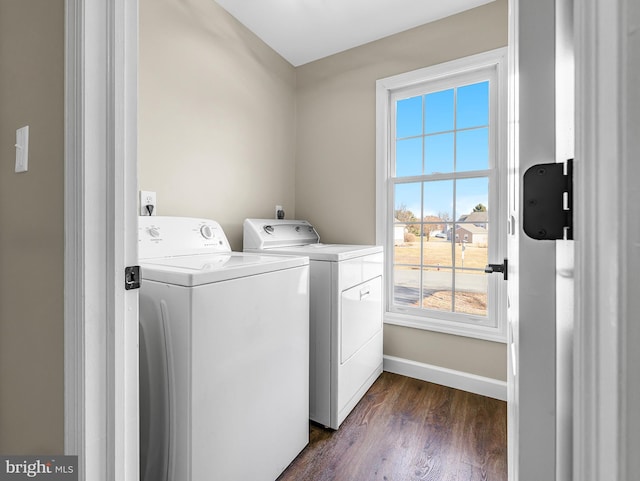 washroom featuring dark hardwood / wood-style flooring and washing machine and dryer