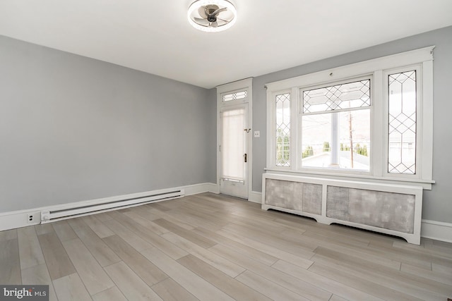 entrance foyer with light wood-type flooring, radiator heating unit, and baseboard heating