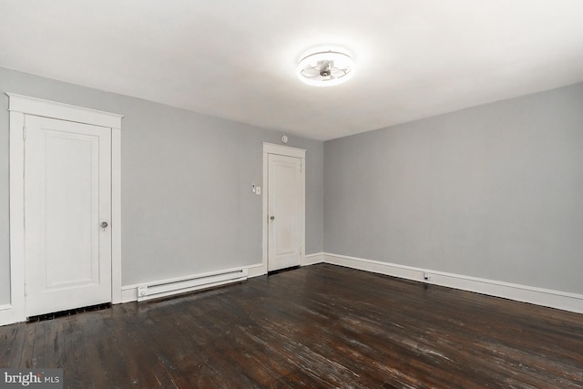 unfurnished room with hardwood / wood-style floors and baseboard heating