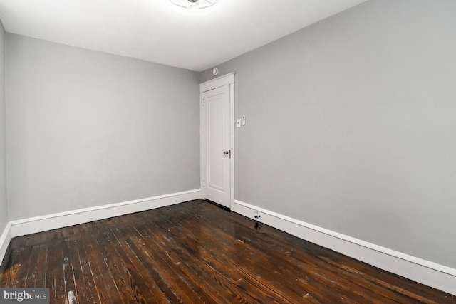 unfurnished room with dark hardwood / wood-style floors