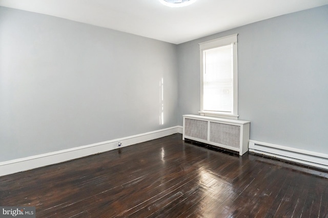 spare room featuring a baseboard radiator, wood-type flooring, and radiator