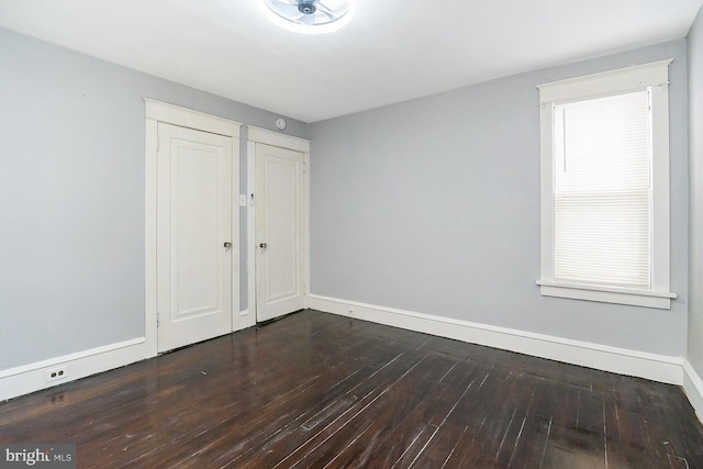 empty room with hardwood / wood-style flooring