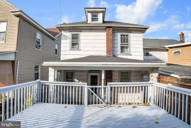 rear view of house featuring a deck