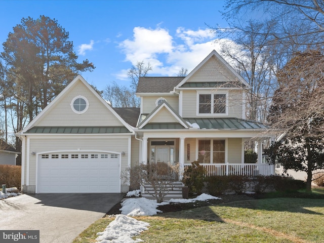 view of front of house featuring a porch, a garage, and a front yard