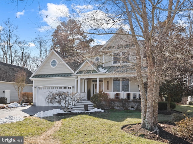 view of front of home featuring a garage, a front lawn, and a porch