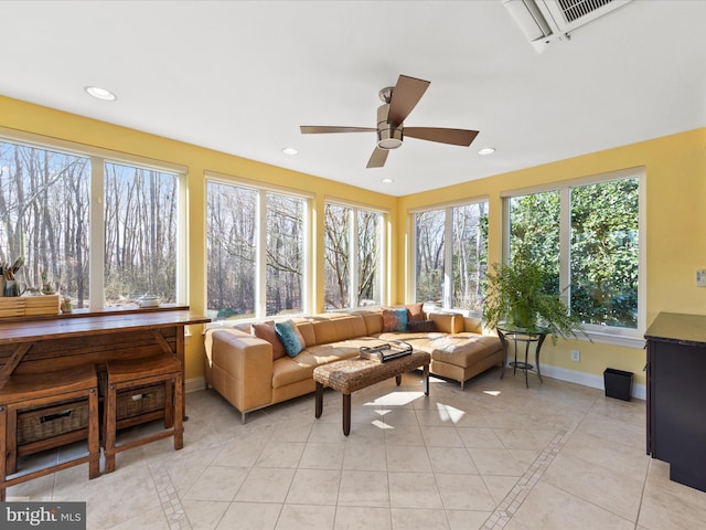 sunroom / solarium featuring ceiling fan