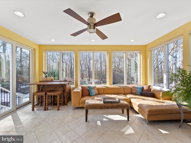 sunroom / solarium featuring ceiling fan