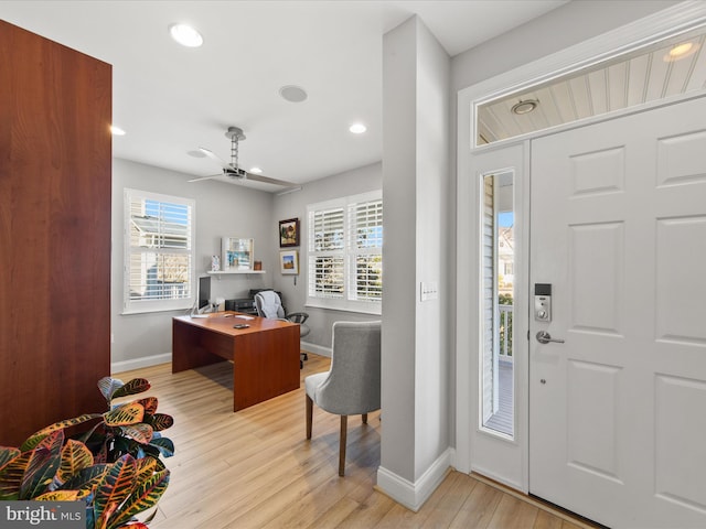 foyer with light hardwood / wood-style floors and ceiling fan