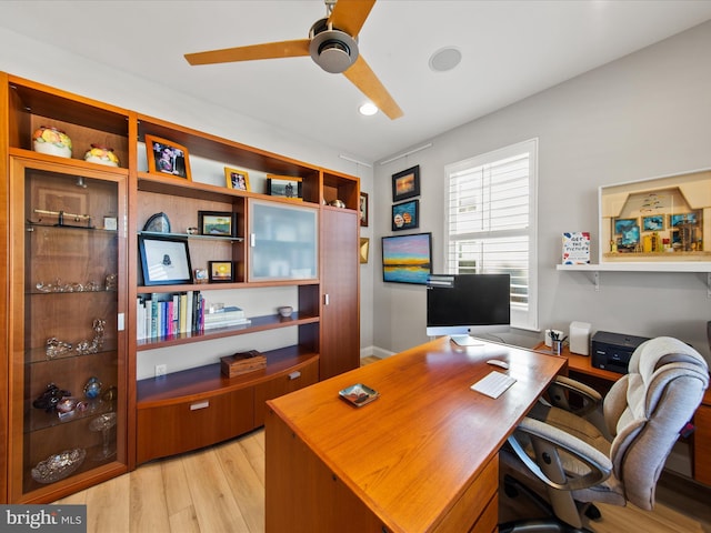 office featuring ceiling fan and light hardwood / wood-style flooring