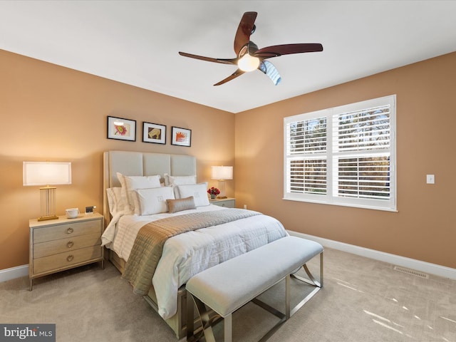 bedroom with light colored carpet and ceiling fan