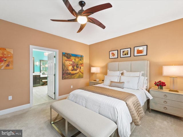 carpeted bedroom featuring ceiling fan and ensuite bathroom