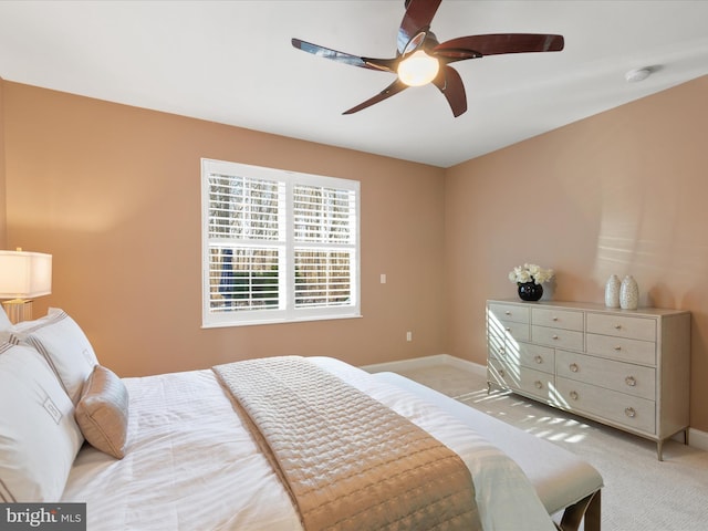 bedroom featuring ceiling fan and light carpet