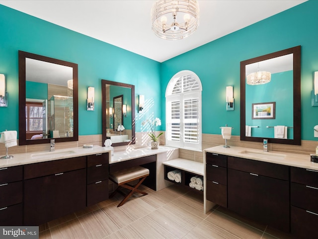 bathroom with vanity, plenty of natural light, an enclosed shower, and a chandelier