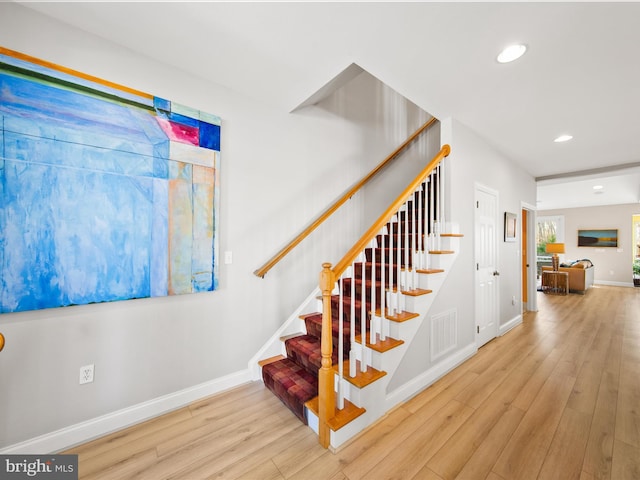 stairs featuring wood-type flooring