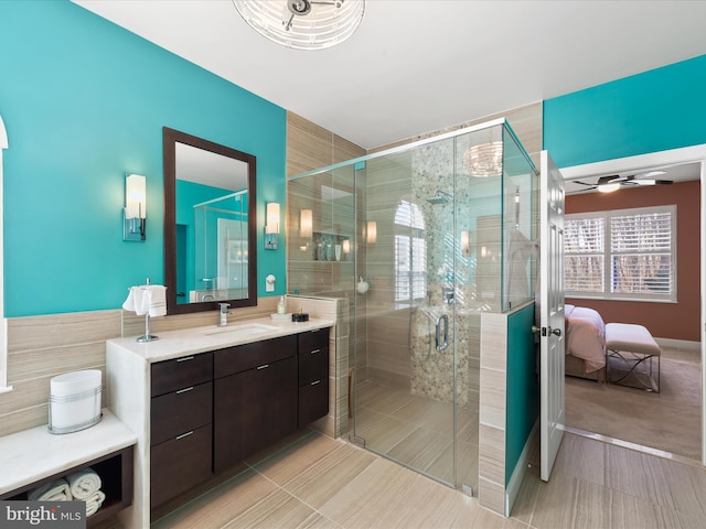 bathroom with vanity, ceiling fan, and walk in shower