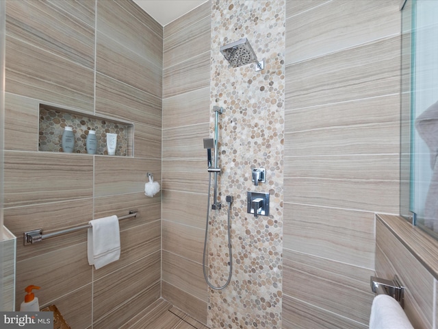 bathroom with tiled shower