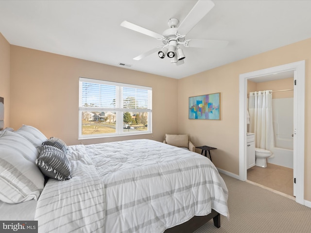 bedroom with light colored carpet and ensuite bathroom