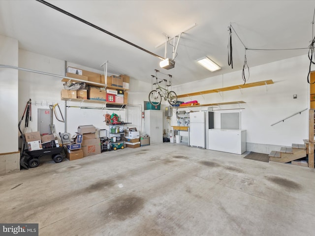 garage with a garage door opener and white fridge