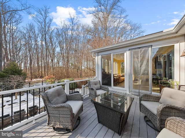 wooden deck featuring outdoor lounge area and a sunroom