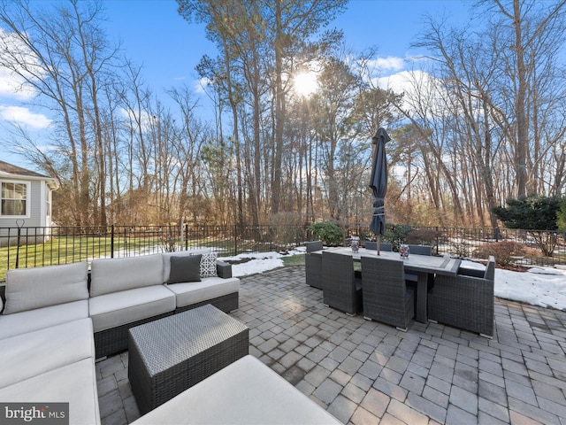 snow covered patio with an outdoor hangout area