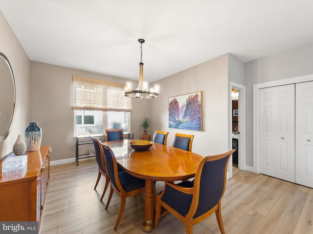 dining room featuring a notable chandelier and light wood-type flooring