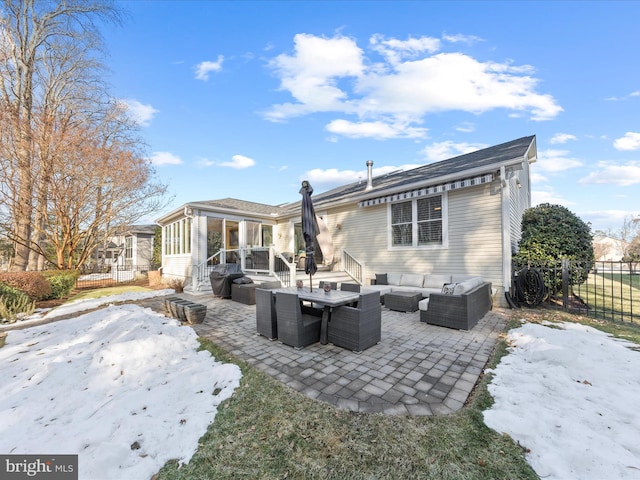 rear view of house featuring a patio, a sunroom, and outdoor lounge area