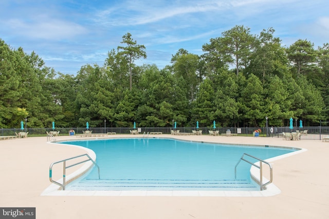 view of swimming pool featuring a patio area