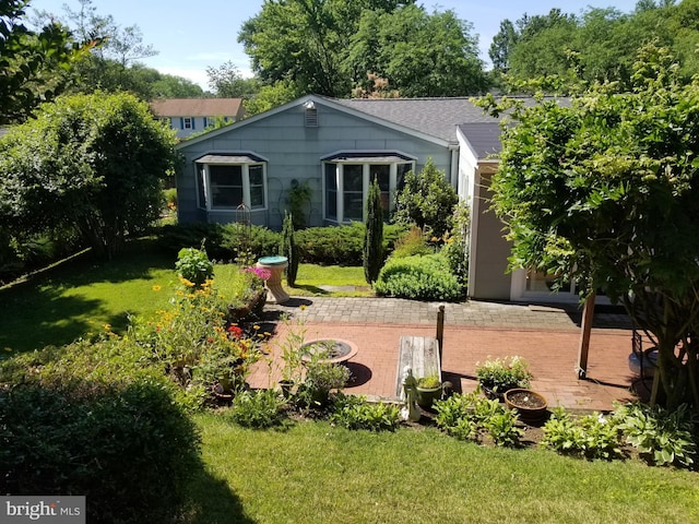 rear view of house featuring a yard and a patio area