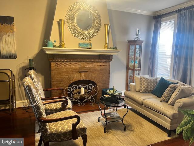 sitting room featuring crown molding and wood-type flooring