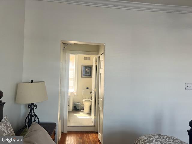 bedroom with wood-type flooring