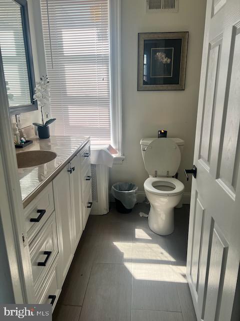 bathroom featuring vanity and toilet