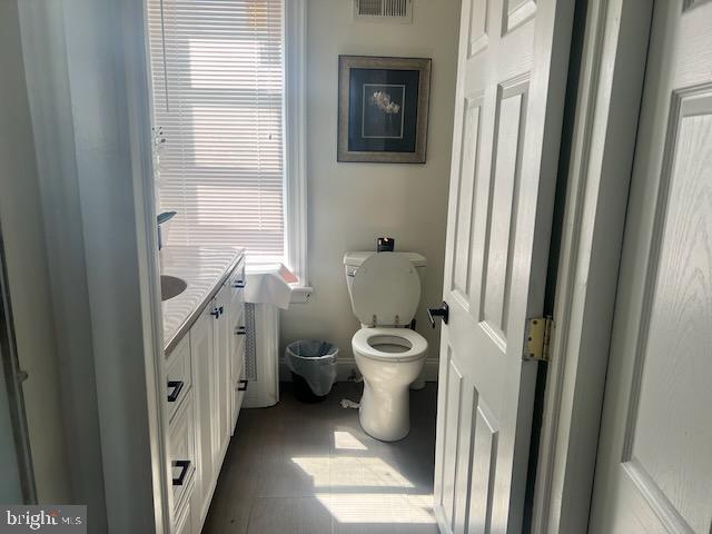 bathroom featuring vanity and toilet