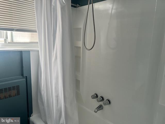 bathroom featuring shower / tub combo with curtain