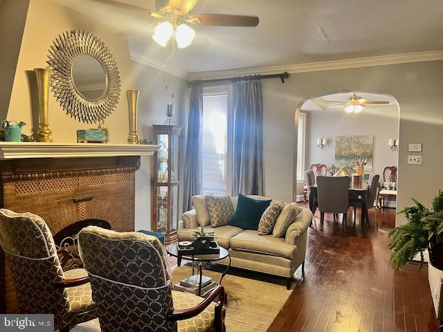 interior space featuring ornamental molding, hardwood / wood-style floors, and ceiling fan