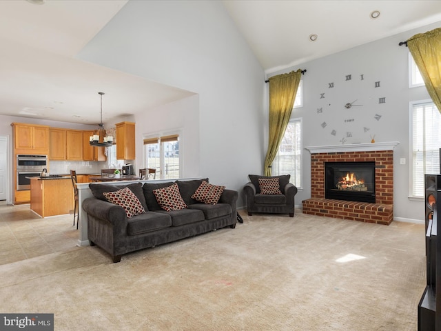 living area featuring a wealth of natural light, light colored carpet, and high vaulted ceiling