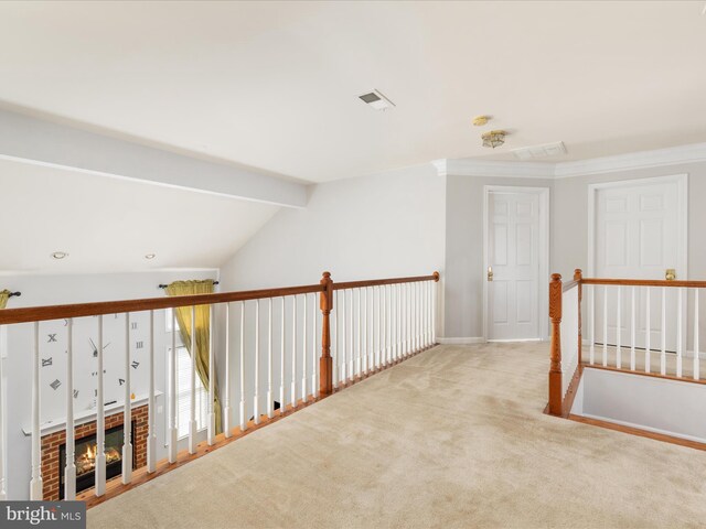 hallway with visible vents, lofted ceiling with beams, and carpet