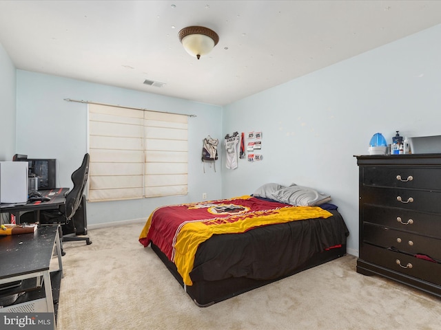 carpeted bedroom featuring baseboards and visible vents