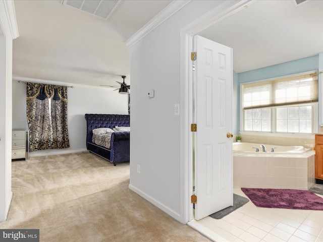 bathroom with a garden tub, baseboards, visible vents, ceiling fan, and crown molding