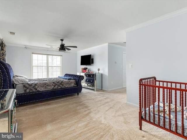 bedroom with visible vents, ceiling fan, baseboards, ornamental molding, and carpet floors