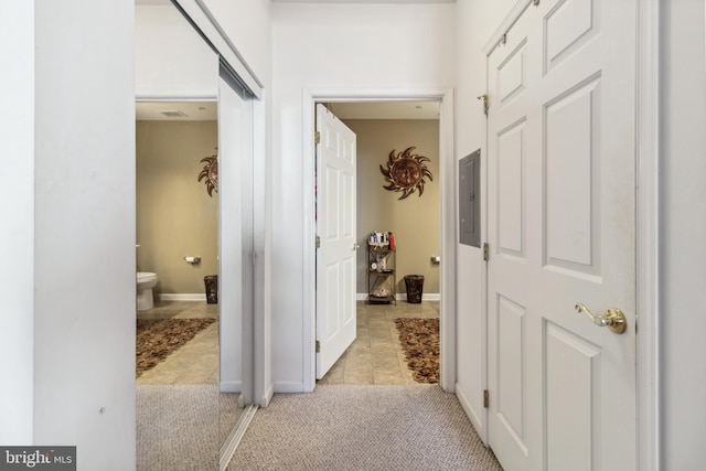 hallway with light tile patterned flooring and electric panel