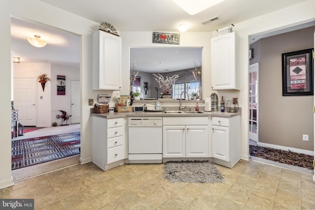 kitchen featuring dishwasher, sink, and white cabinets