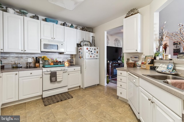 kitchen with white cabinetry, backsplash, white appliances, and sink