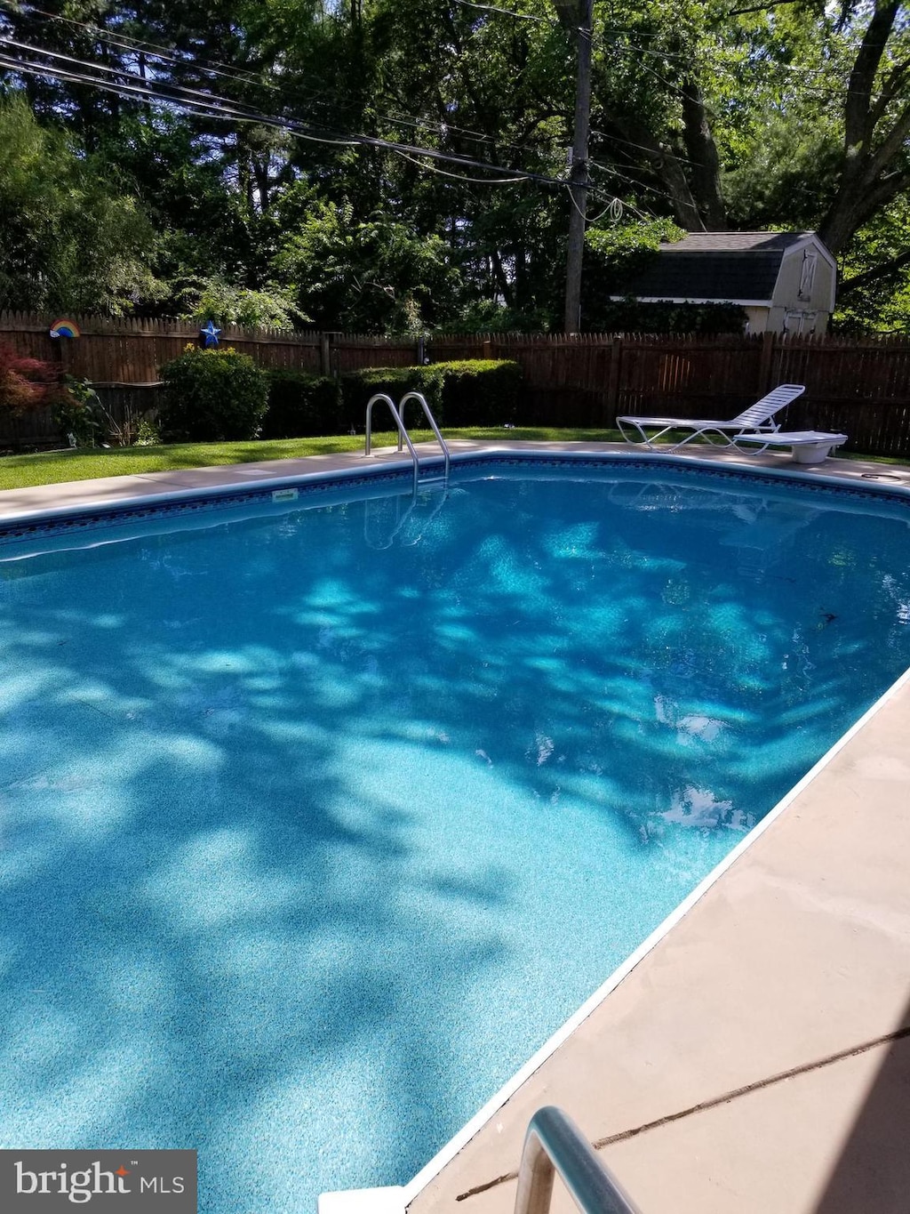 view of pool with a diving board