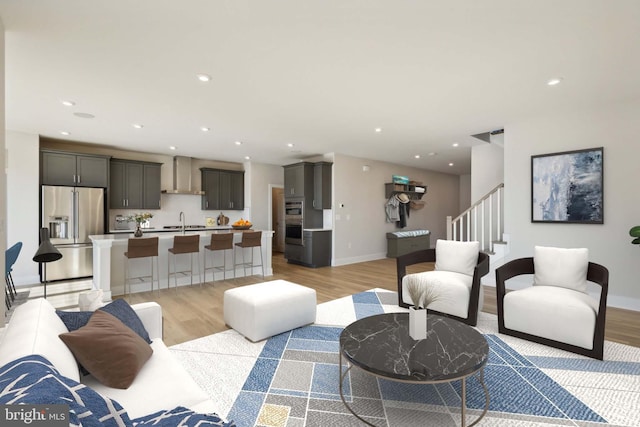 living room with sink and light hardwood / wood-style floors