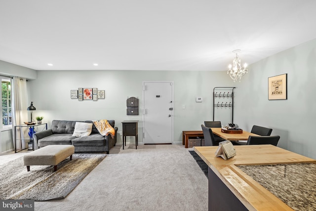 carpeted living room with an inviting chandelier