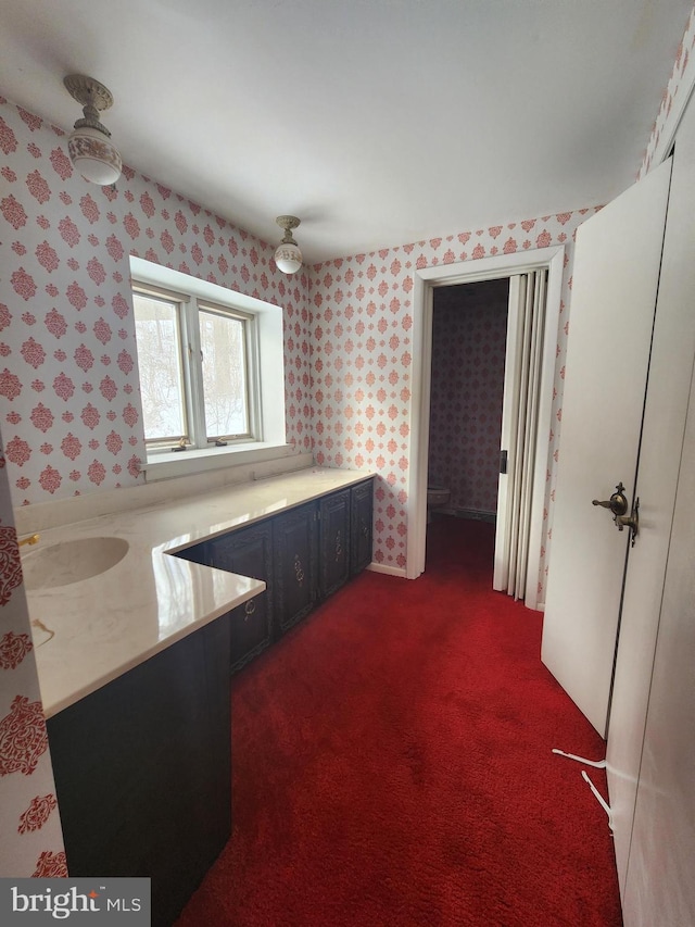 980 Creek Rd, Downingtown, PA 19335 - kitchen with wallpapered walls, dark carpet, and light countertops